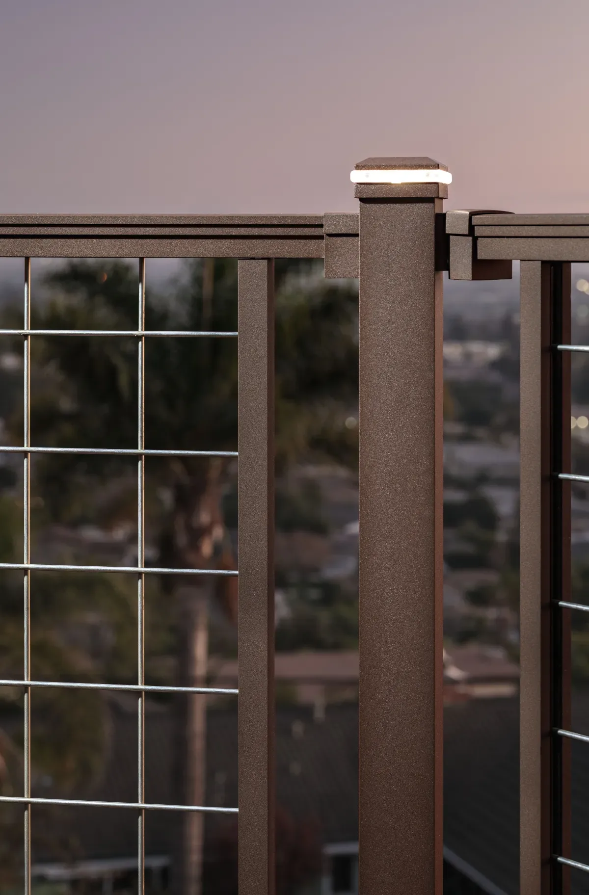 Trex post cap light on railing at dusk